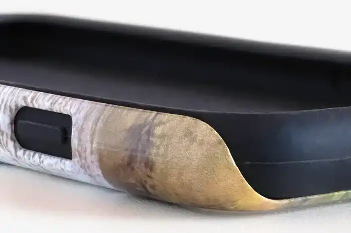 Damaged smartphone battery that appears to be swollen and bulging out of its casing.