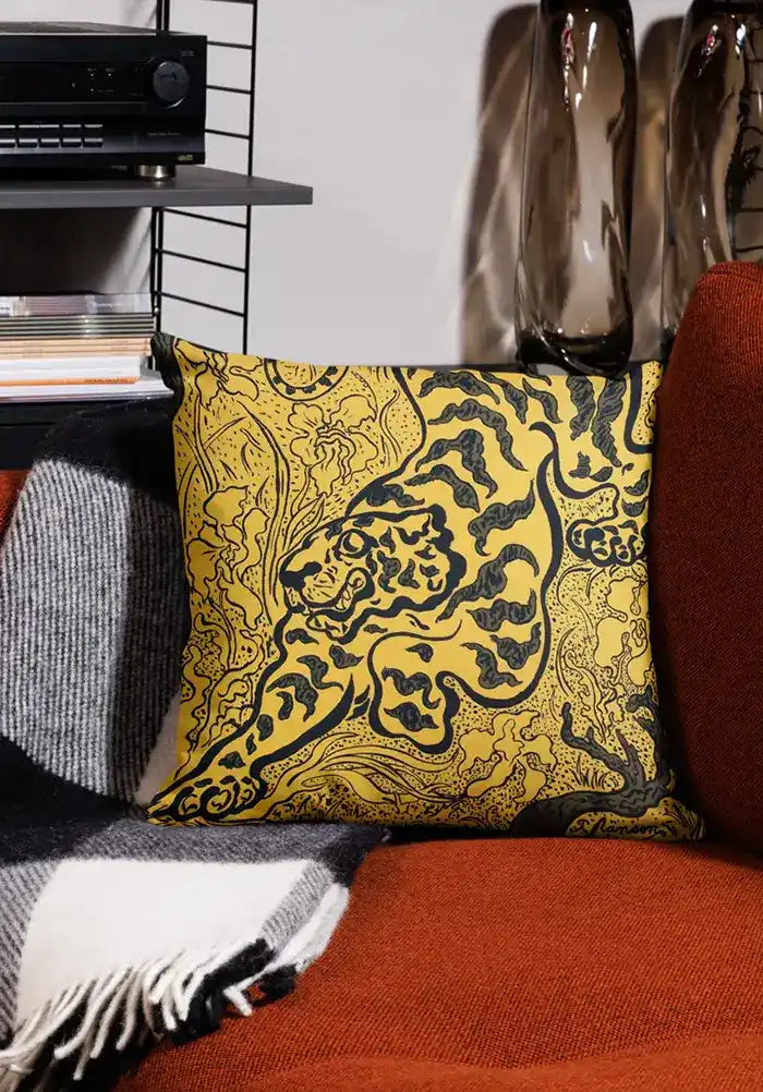 Decorative yellow and black throw pillow with an ornate damask pattern.