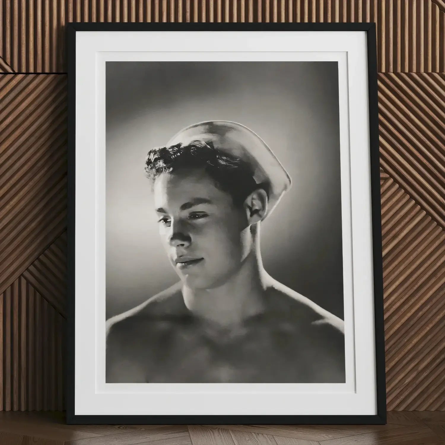 Framed black and white portrait of a young man in a sailor cap from Bob Mizer’s queer chronicle