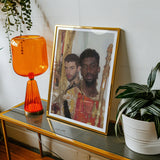 Hadrian & Antinous - Gay Interracial Couple Art Print, Framed Photograph Alongside Orange Table Lamp Potted Plant