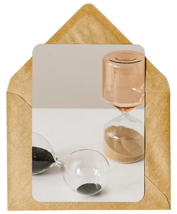 Hourglass with sand inside a golden envelope frame.