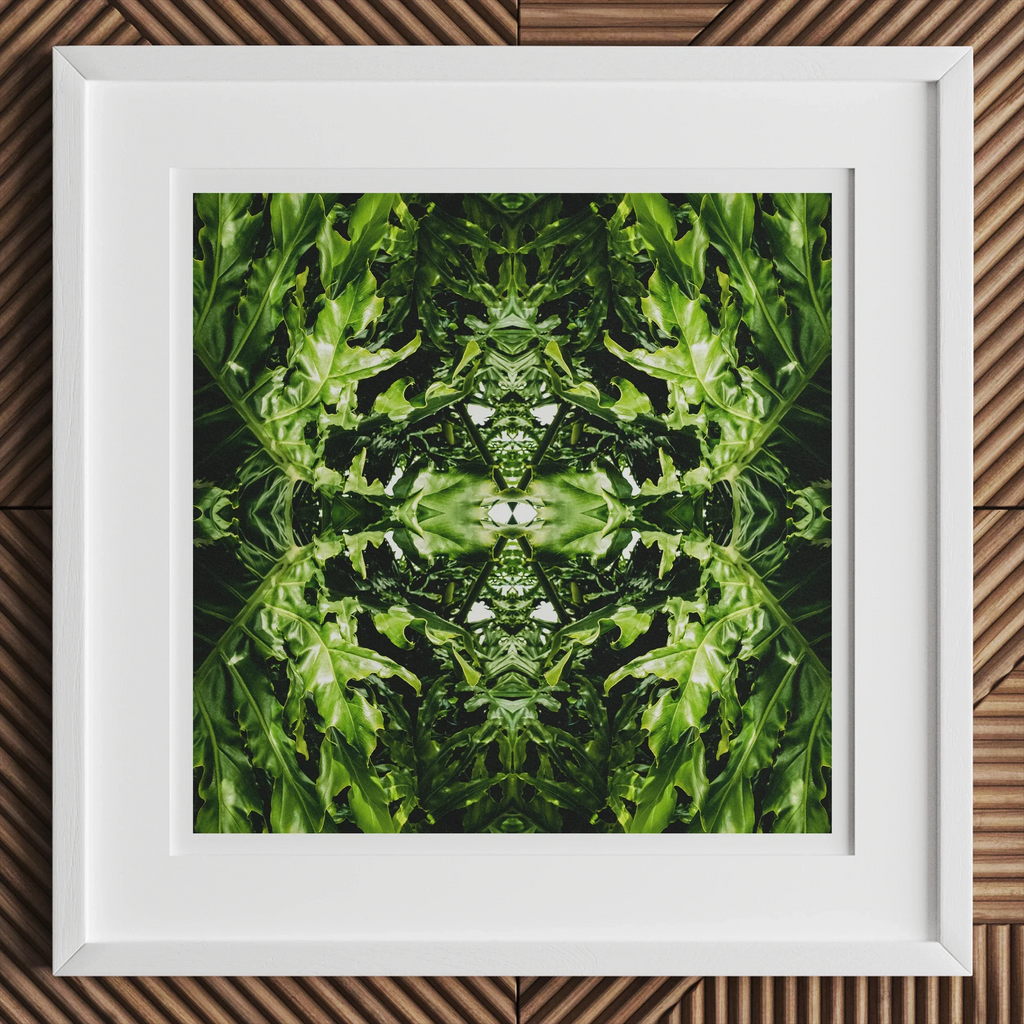 Framed abstract botanical op art featuring symmetrical green foliage and trippy tree trunk design