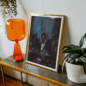 Thorne - Gay Black Dracula Art Print, Framed Concert Photograph Alongside Orange Glass Table Lamp