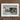 White-framed Artwork Dramatic Maritime Rescue Scene Figures Turbulent Two Men, Dark Teal Wave, Gathers, Four Locked, Surf’s Lateral Drag,
