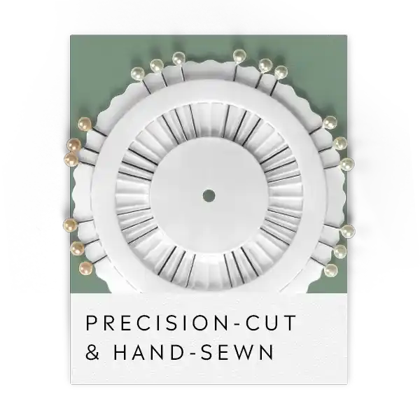 White circular pin cushion with straight pins arranged around its perimeter.